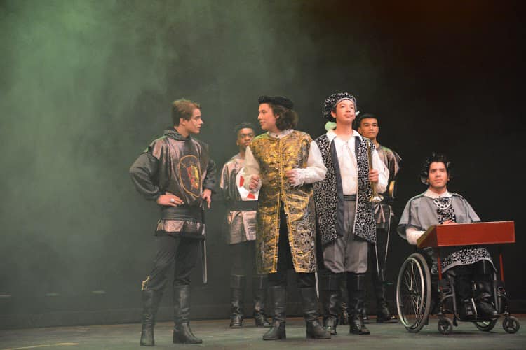 5 people, 2 people facing each other, 3people facing the camera 